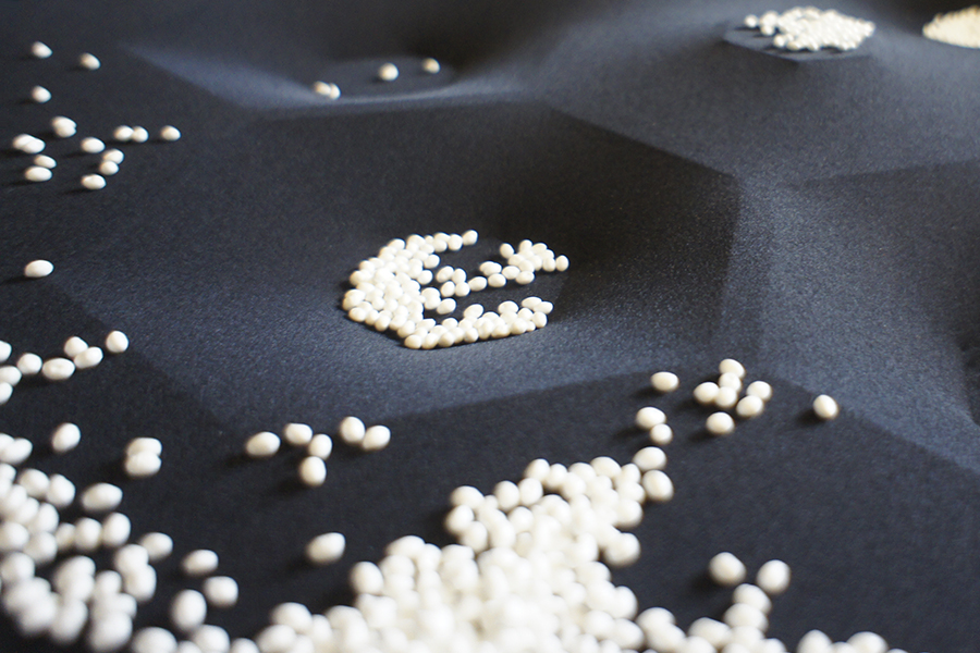 Photo small polystyrene balls on black stretched fabric honeycomb deepening