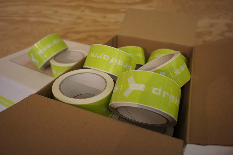 Photo green adhesive tape rolls in carton dreiform logo