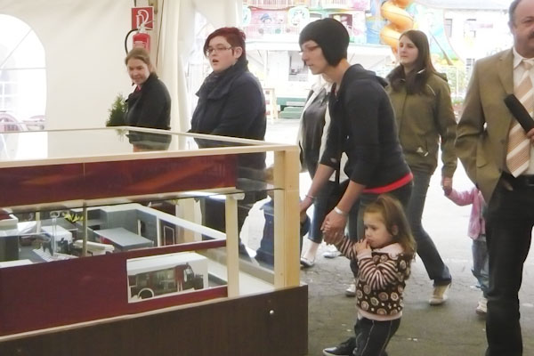 Photo showcase with model of the new building