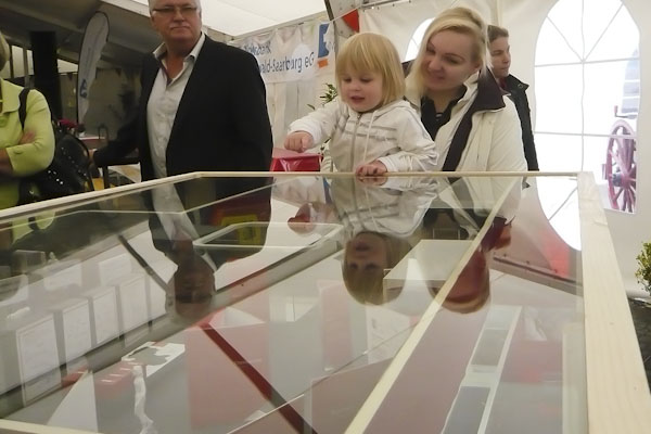 Photo showcase with model of the new building