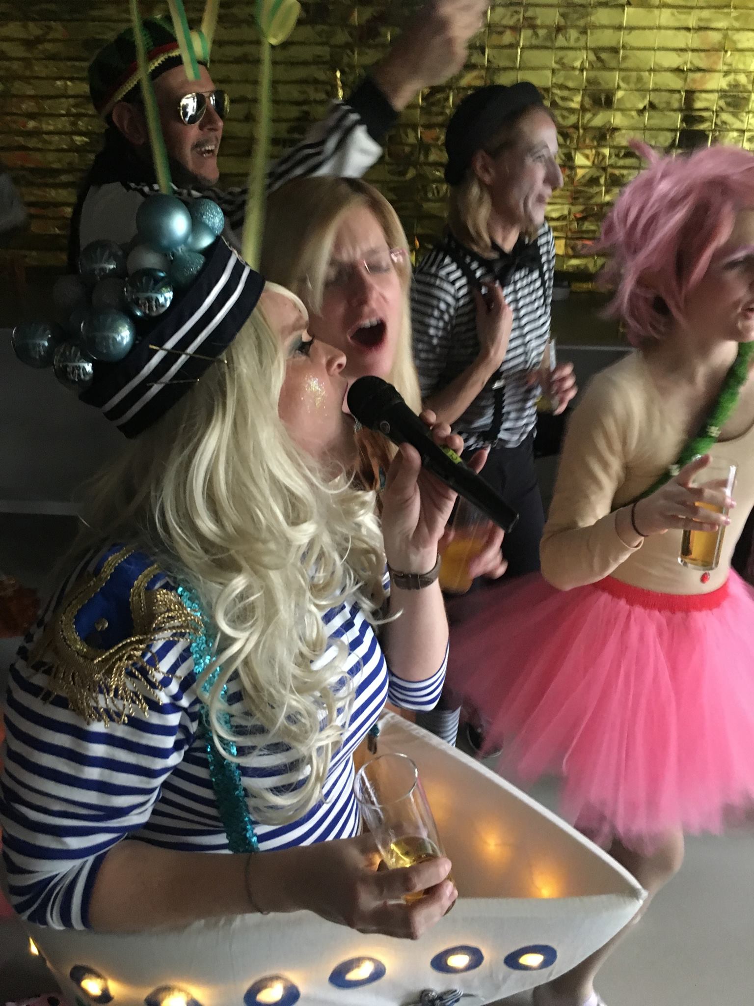 photo dreifrom employees dressed up singing microphone