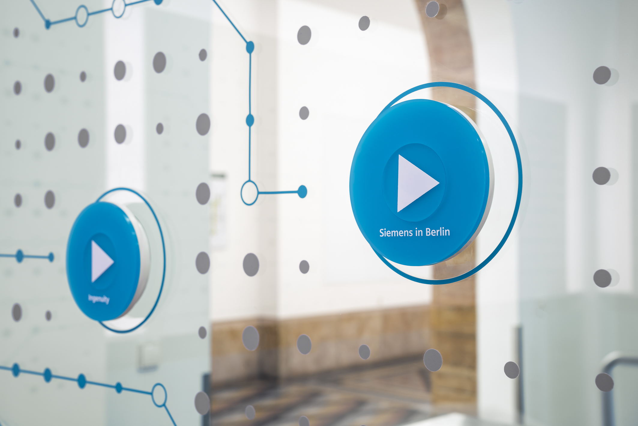 Close-up of the interactive blue buttons on glass wall