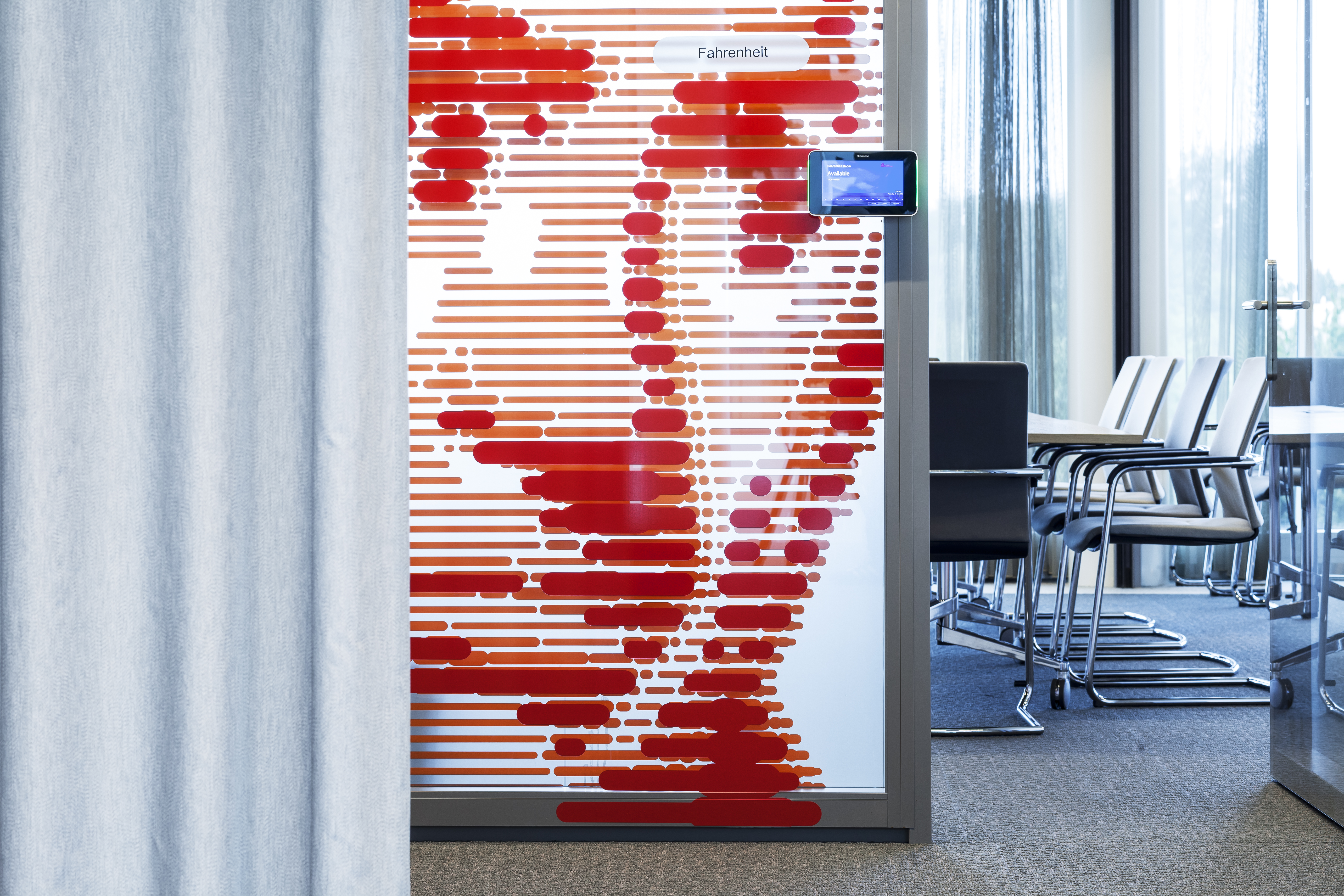 Glass door of conference room with portrait made of layered lines