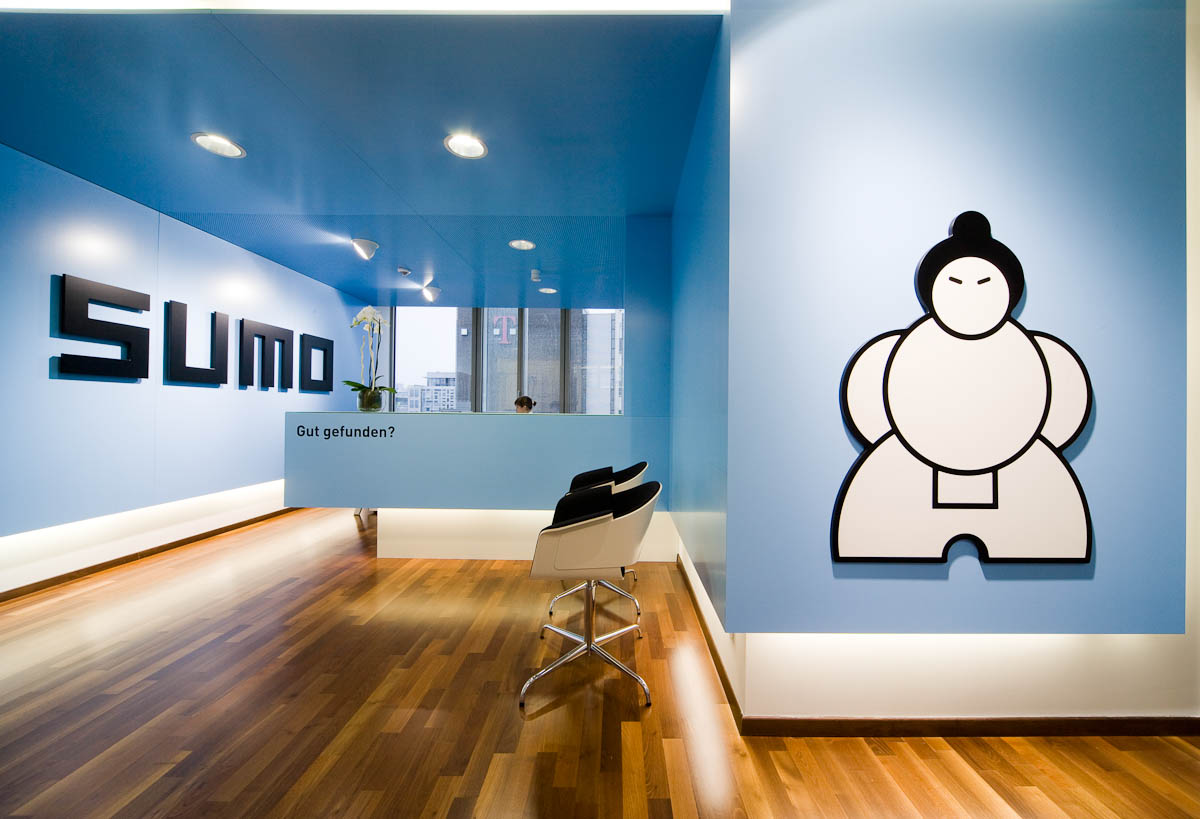 bright entrance area with blue walls and large wood Sumo logo