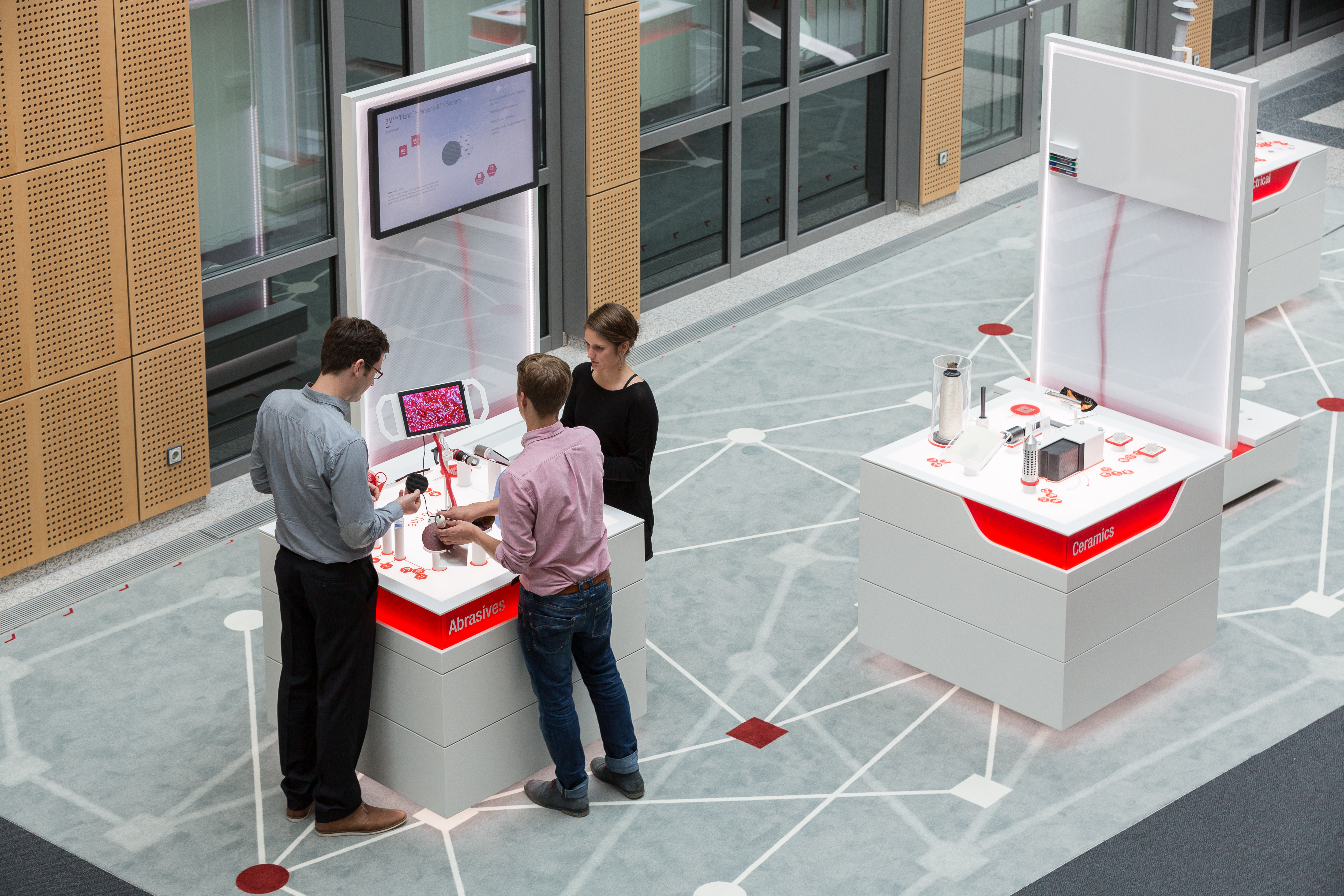 Three visitors interact with the exhibit