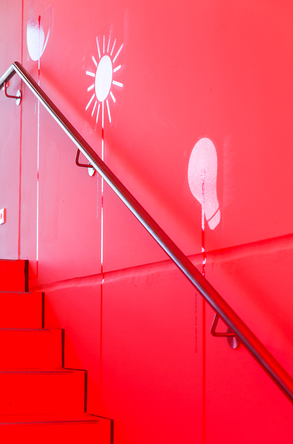 Red staircase with white graphics on the wall