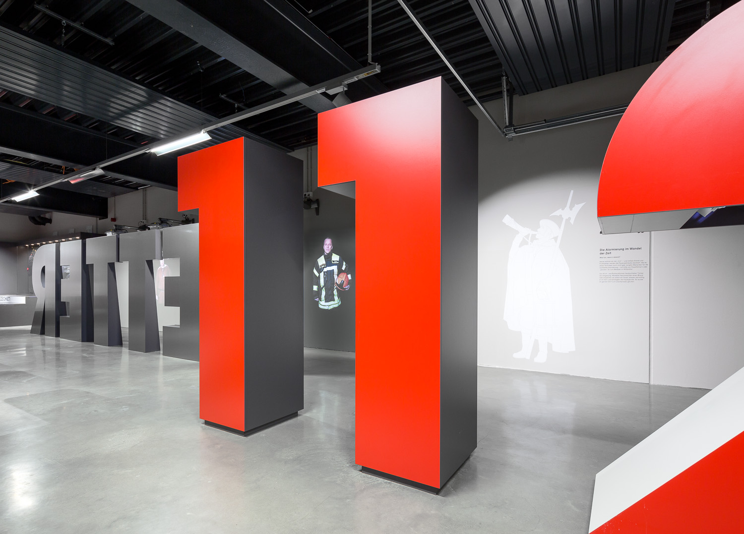 Large red numbers and black letters stand in the middle of the room