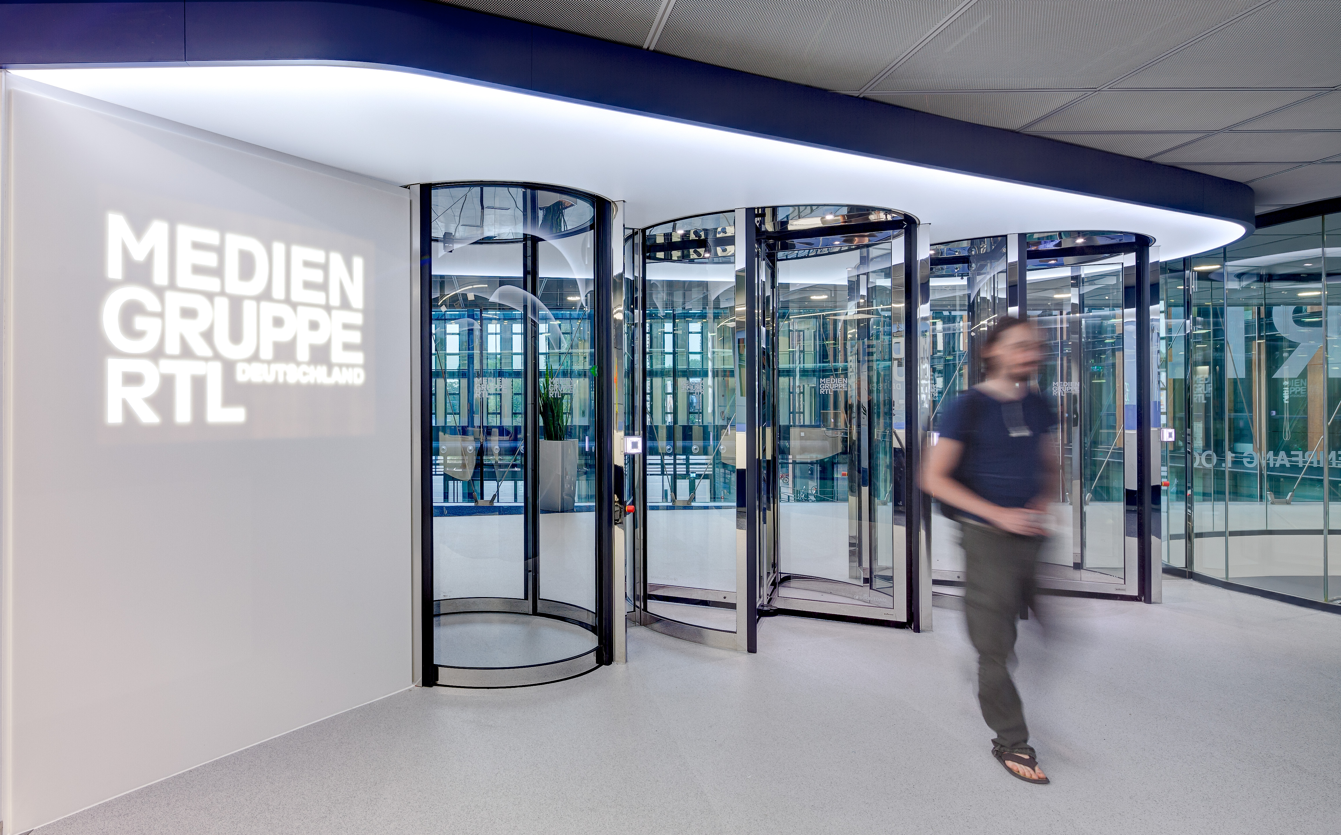 Secure entrance gates and projected company logo on the wall