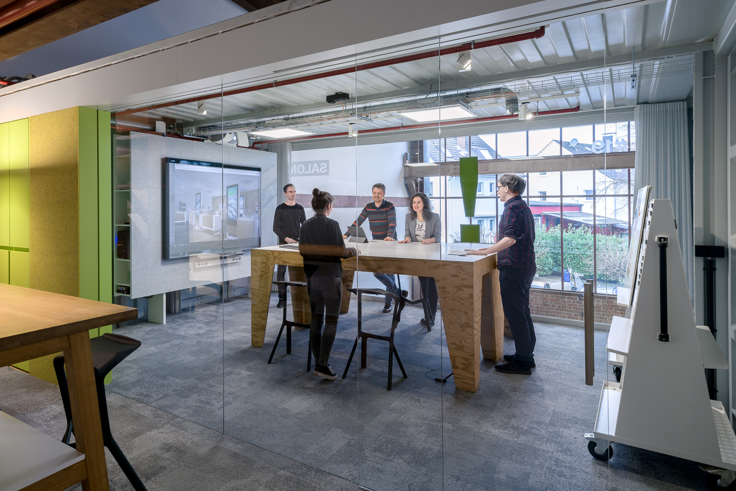 People in sea container Meeting room with large Smartboard