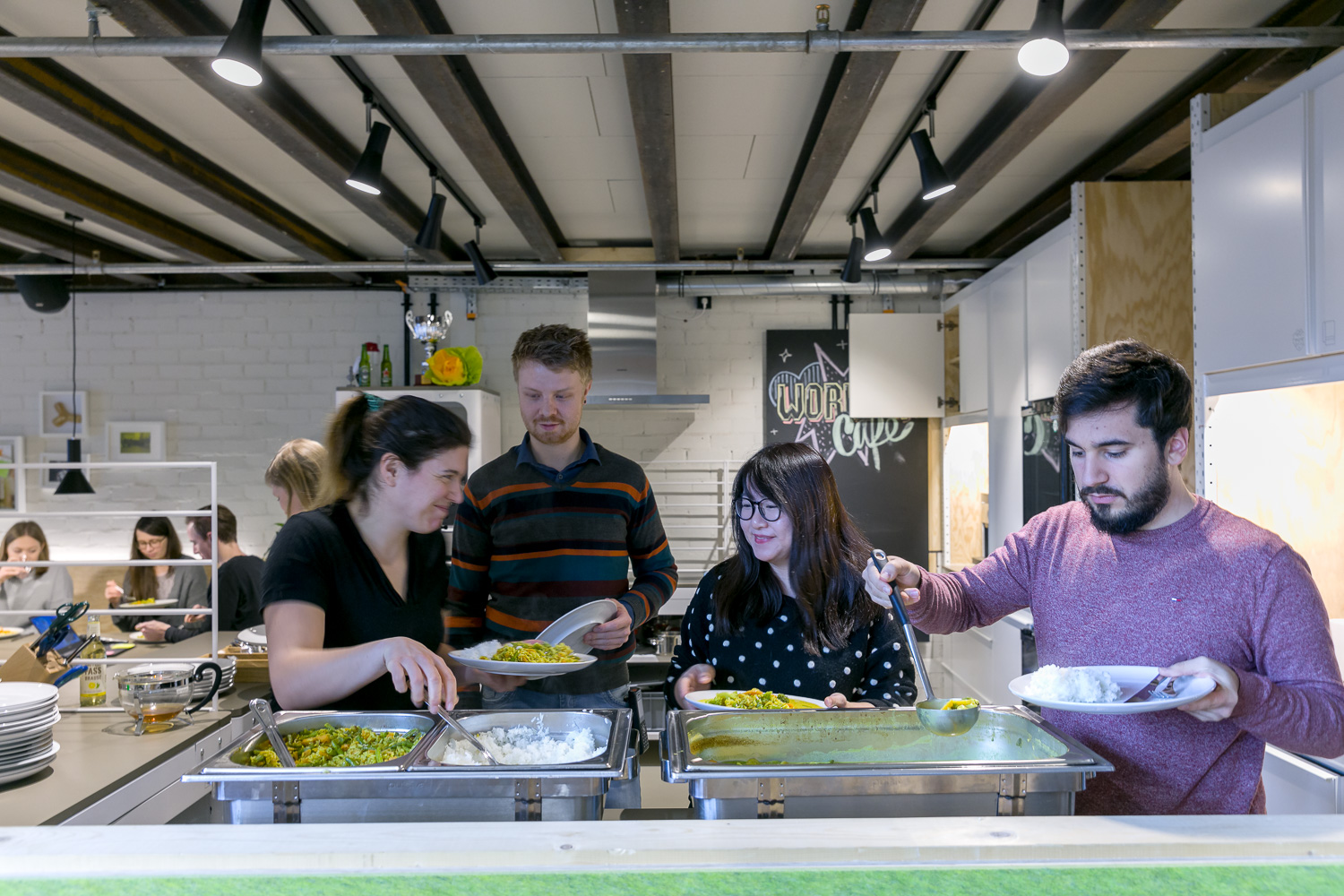 Employees at the team dinner in the kitchen